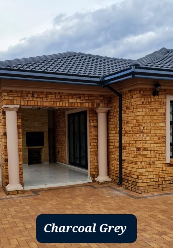 Charcoal grey gutters above a paved patio